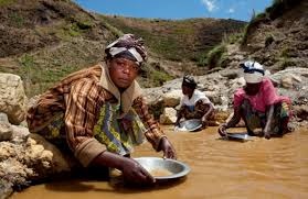 Rural women fetching water near polluted mining area