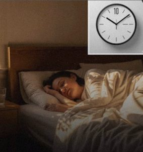 Woman checking time during repeated night awakenings