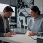 Business partners discussing product quantity before signing a contract.