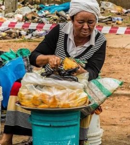 Nigerians eating local foods while health experts warn about food safety and preventable diseases