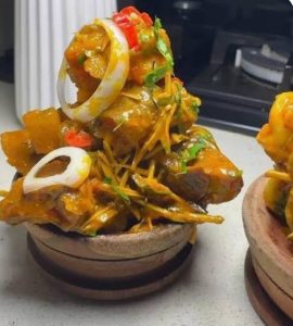 Nigerians eating local foods while health experts warn about food safety and preventable diseases